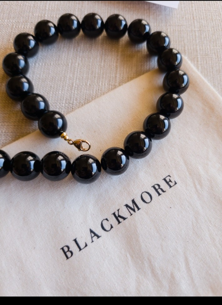 BLACKMORE Black Onyx beaded necklace styled with branded fabric packaging